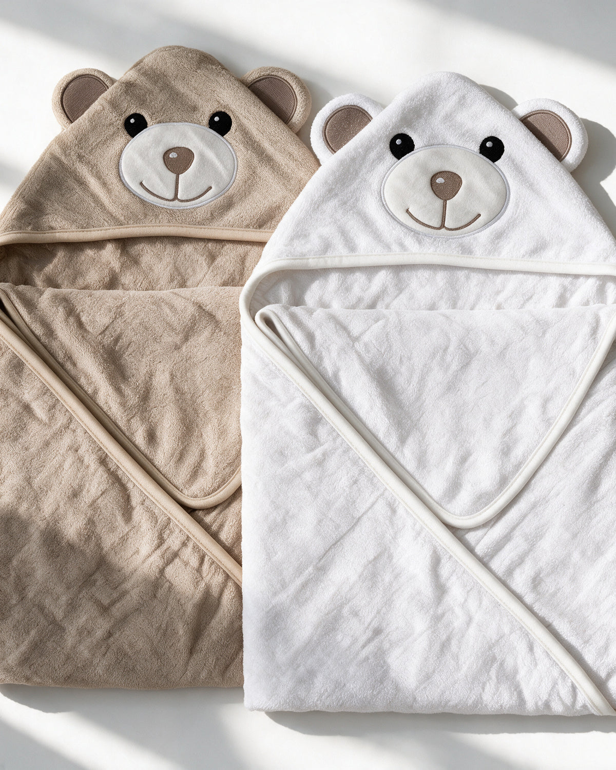 Close-up of the Cream Bear and Little Bear hooded towels side by side
