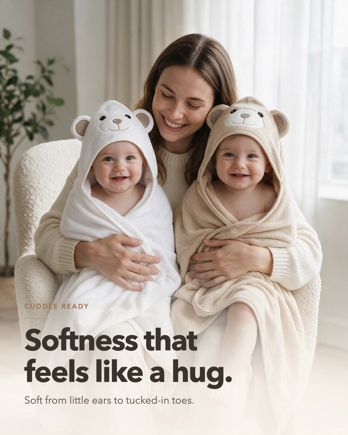 Mother holding two babies wrapped in the Cream Bear and Little Bear hooded towels