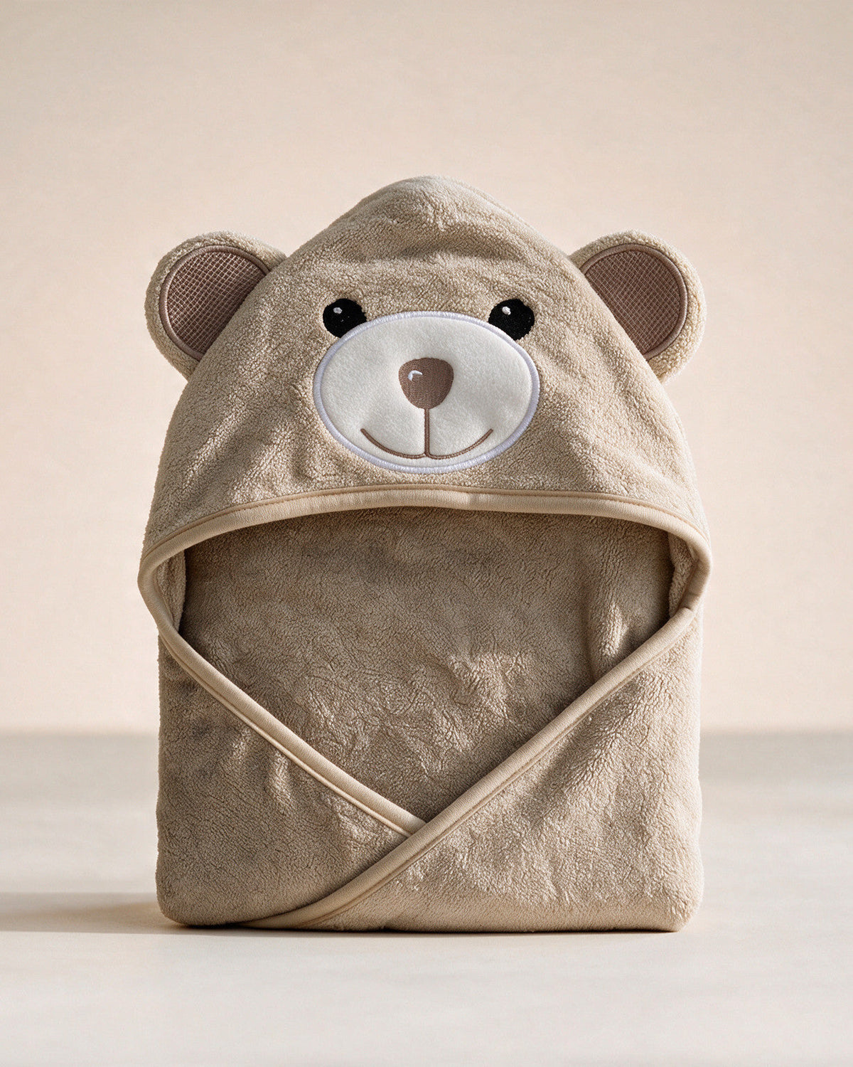 Cream Bear hooded baby towel in warm sand beige, on a cream background