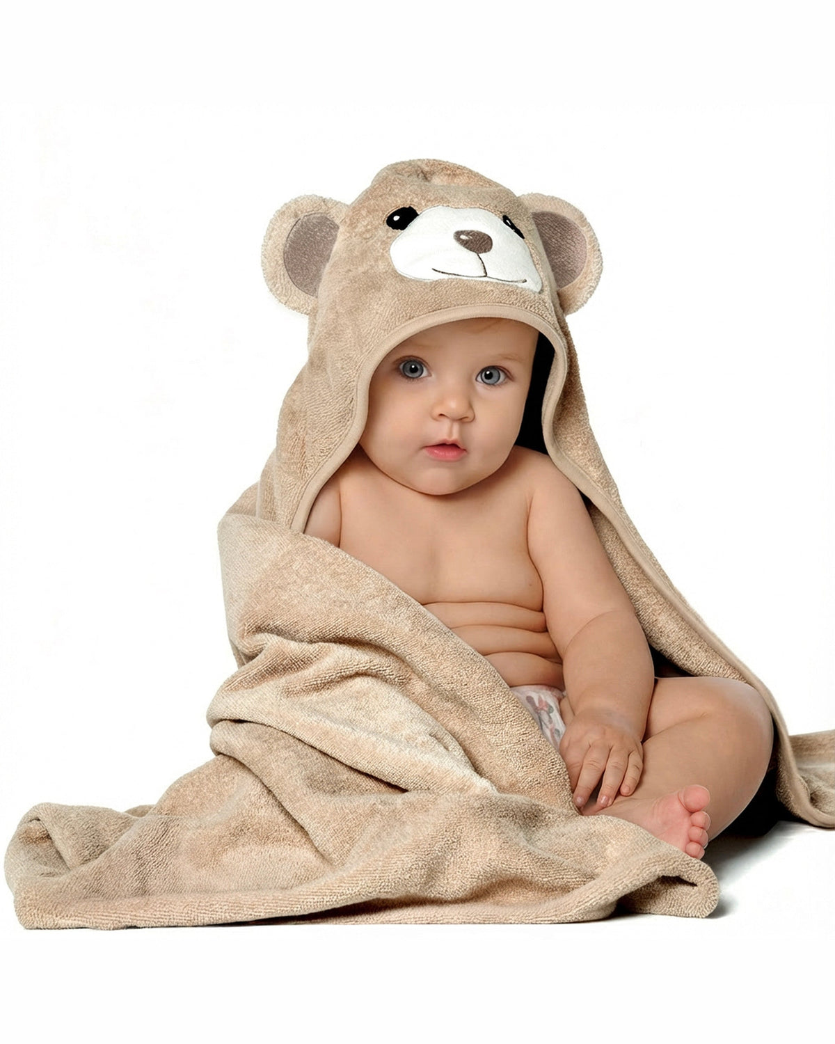 Baby sitting wrapped in the Cream Bear hooded towel, on white