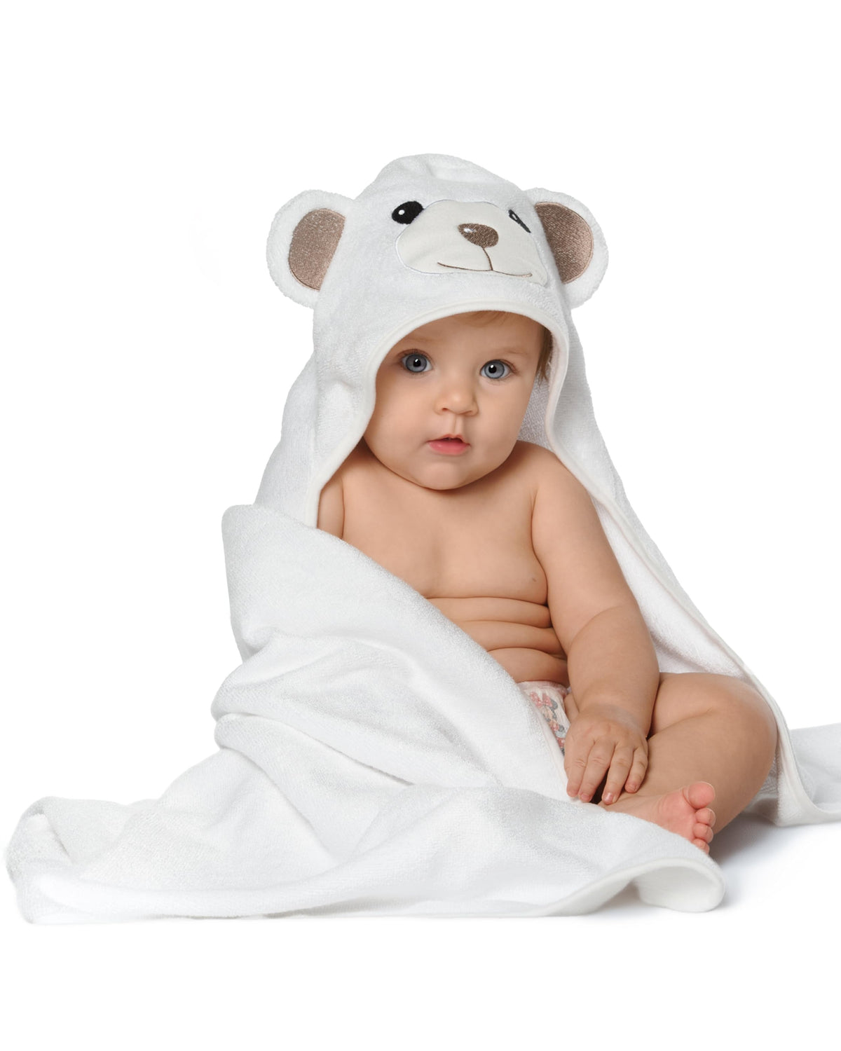 Baby sitting wrapped in the Little Bear hooded towel, on white