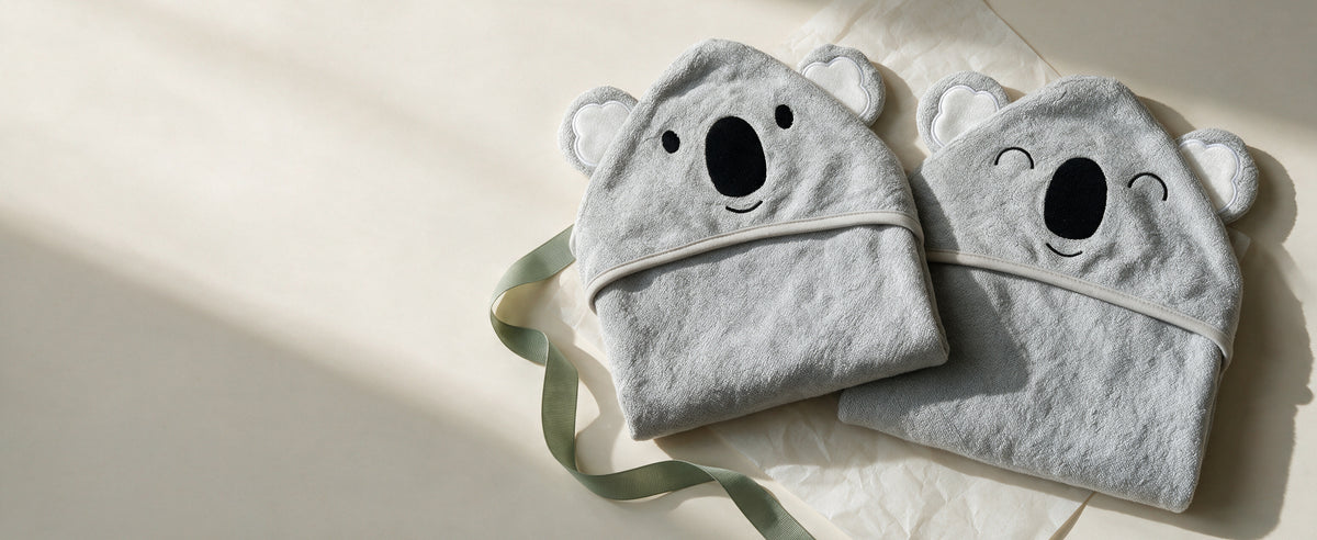 The Koala and Sleepy Koala towels with a sage ribbon