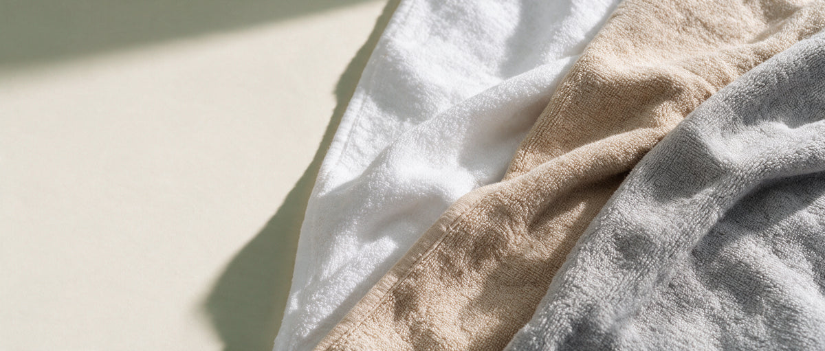 White, cream and grey MiniBoo terry towels in soft window light