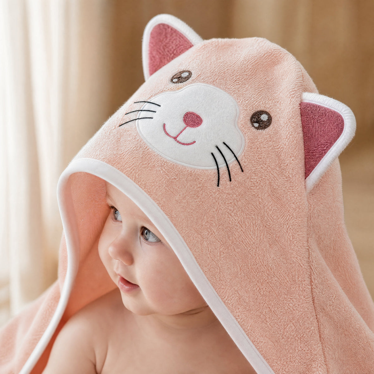 Close-up of the embroidered cat face on The Cat hooded towel