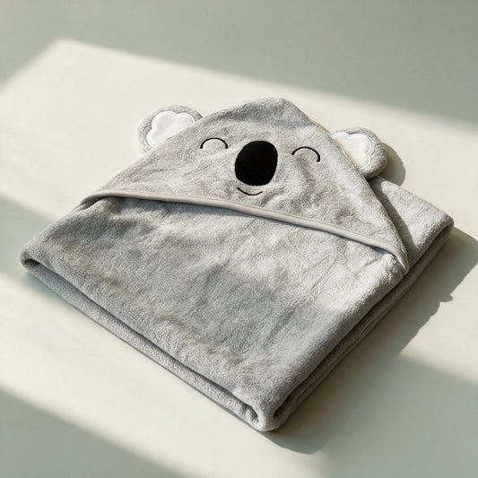 Prosopul cu glugă Sleepy Koala, cu ochi brodați închiși, întins complet, în lumină naturală blândă
