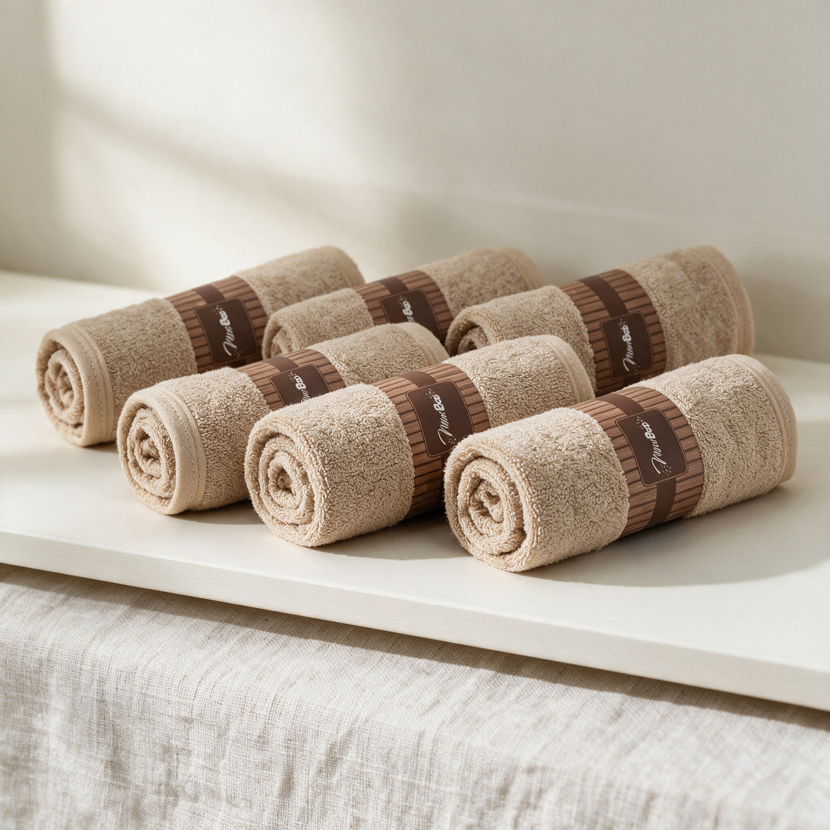 Cream MiniBoo washcloths rolled with kraft bands