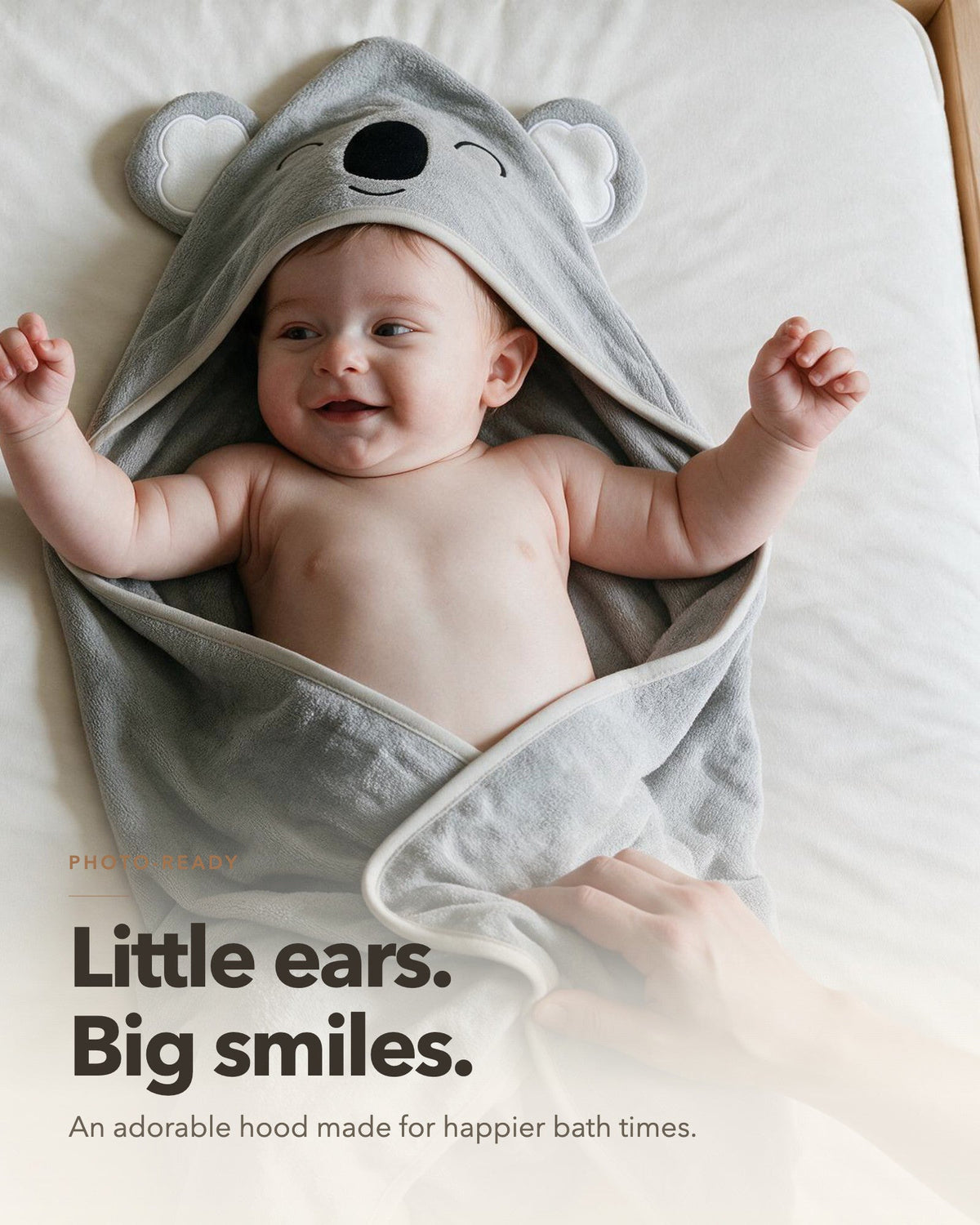 Little ears, big smiles – baby lying on the Sleepy Koala towel