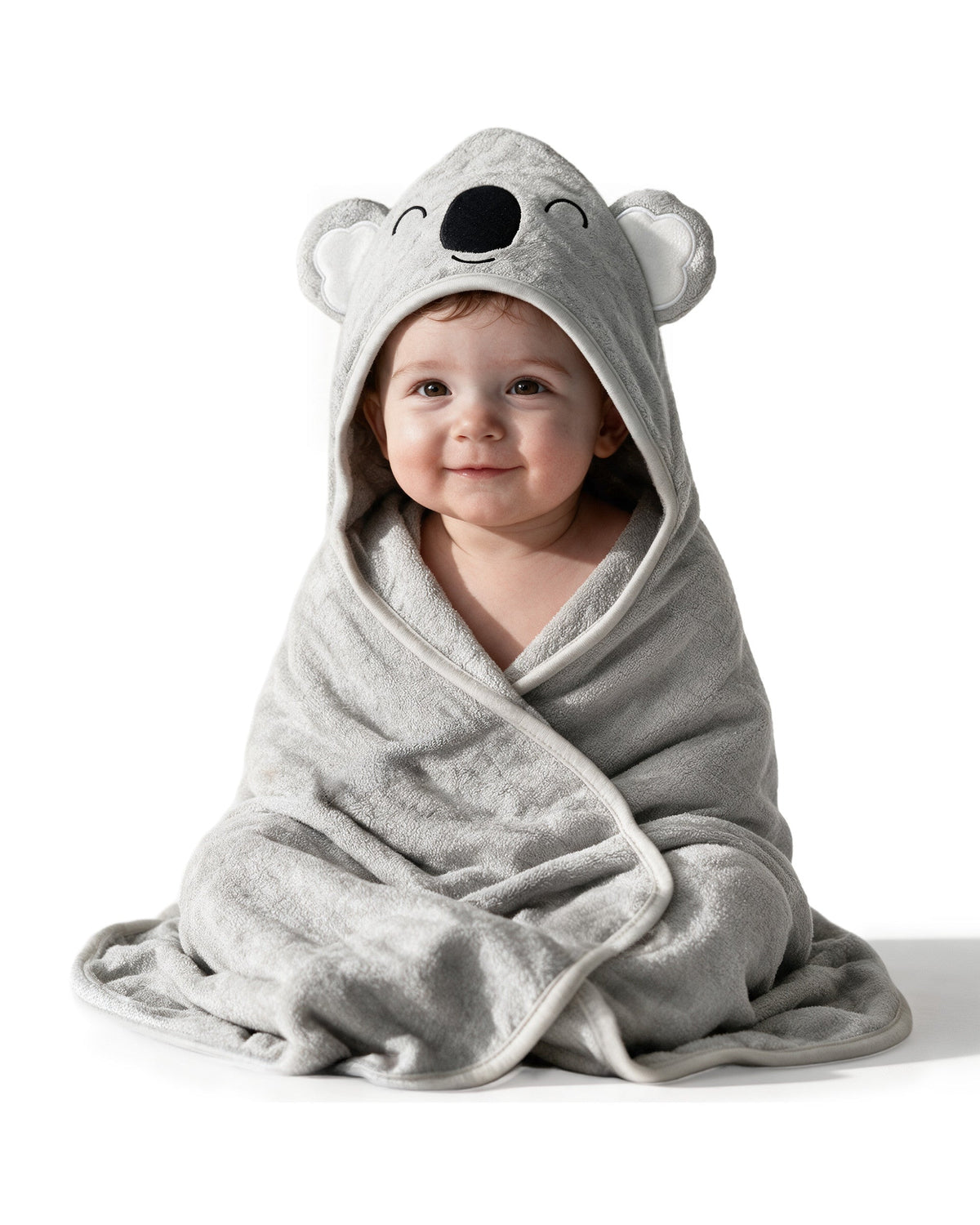 Baby sitting wrapped in the Sleepy Koala towel, on white