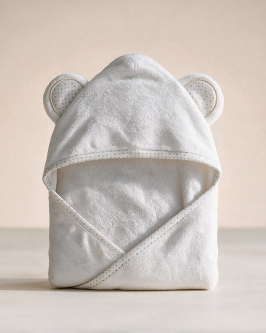 Starry Bear hooded baby towel in white with star-print ears and trim, on a cream background