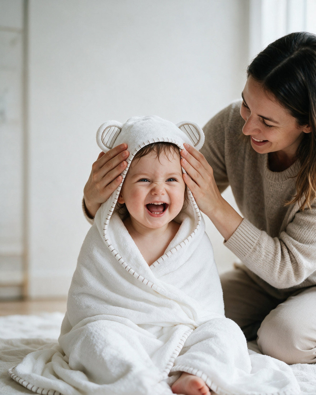 Mother adjusting the hood of the Striped Cub towel
