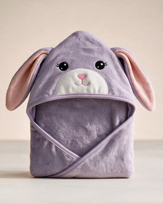 The Bunny hooded baby towel in soft lavender with long ears, on a cream background