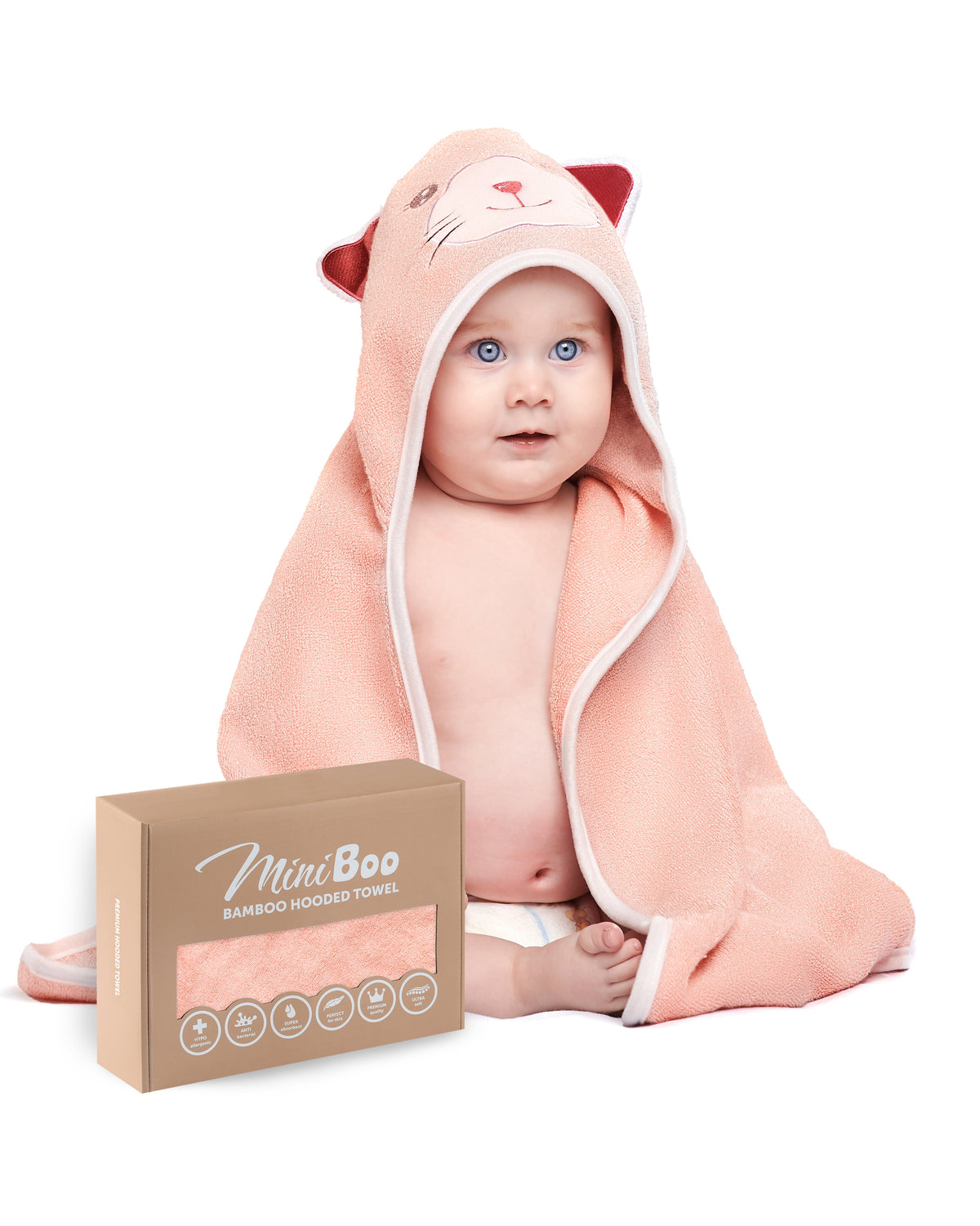 Baby sitting wrapped in The Cat hooded towel, with its MiniBoo gift box, on white