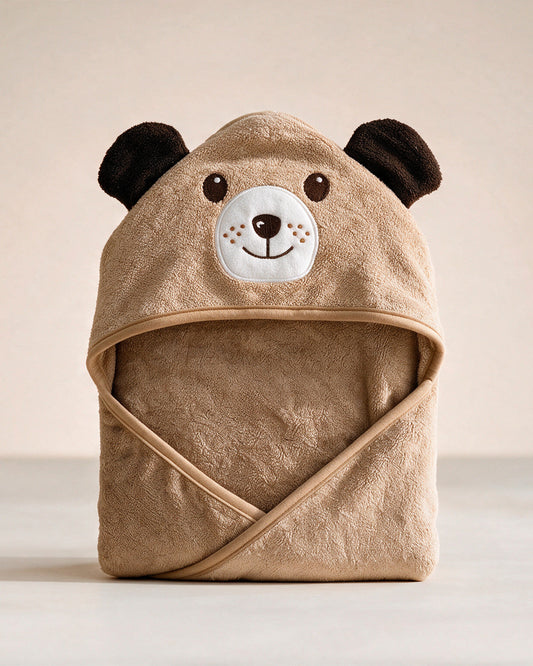 The Dog hooded baby towel in caramel brown, standing on a cream background