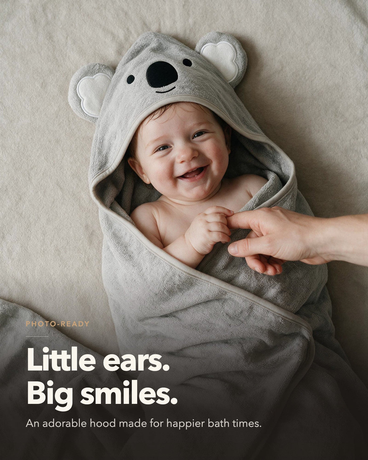 Little ears, big smiles – baby lying on The Koala towel